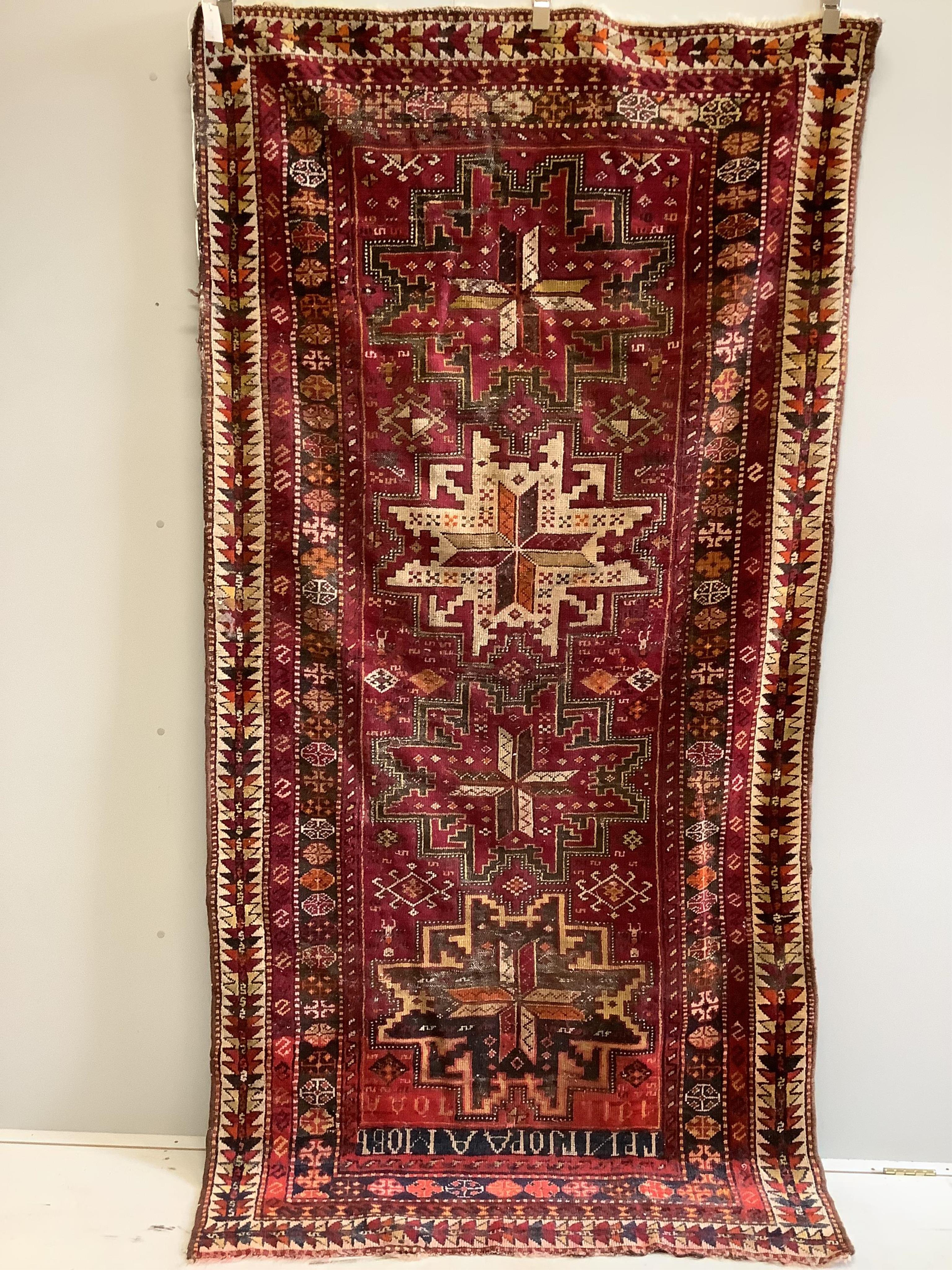 A Caucasian red ground rug, 250 x 130cm. Condition - fair